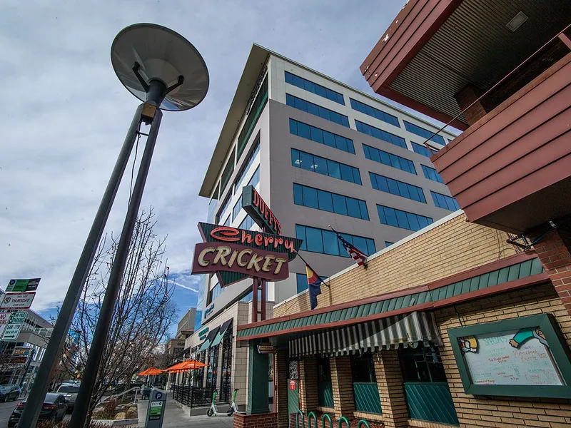 Vintage Cherry Cricket sign outside The Cherry Cricket burger tavern on E 2nd Ave in Cherry Creek, home of some of the best burgers in Denver