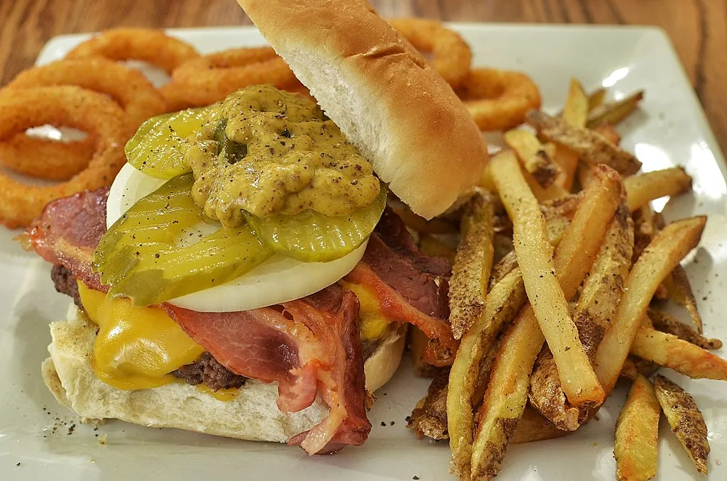 Bacon cheeseburger with fries — illustrates Babyfacu with bacon jam at Burger &amp; Beyond Soho. Generic photo, not the actual dish. Alt: Burger &amp; Beyond Soho smash burger with bacon jam