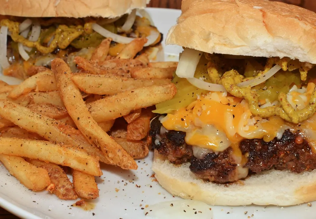 Honest Burgers style beef cheeseburger with chips — order it pink with unlimited homemade chips in Brixton. Alt: Honest Burgers London beef burger with chips