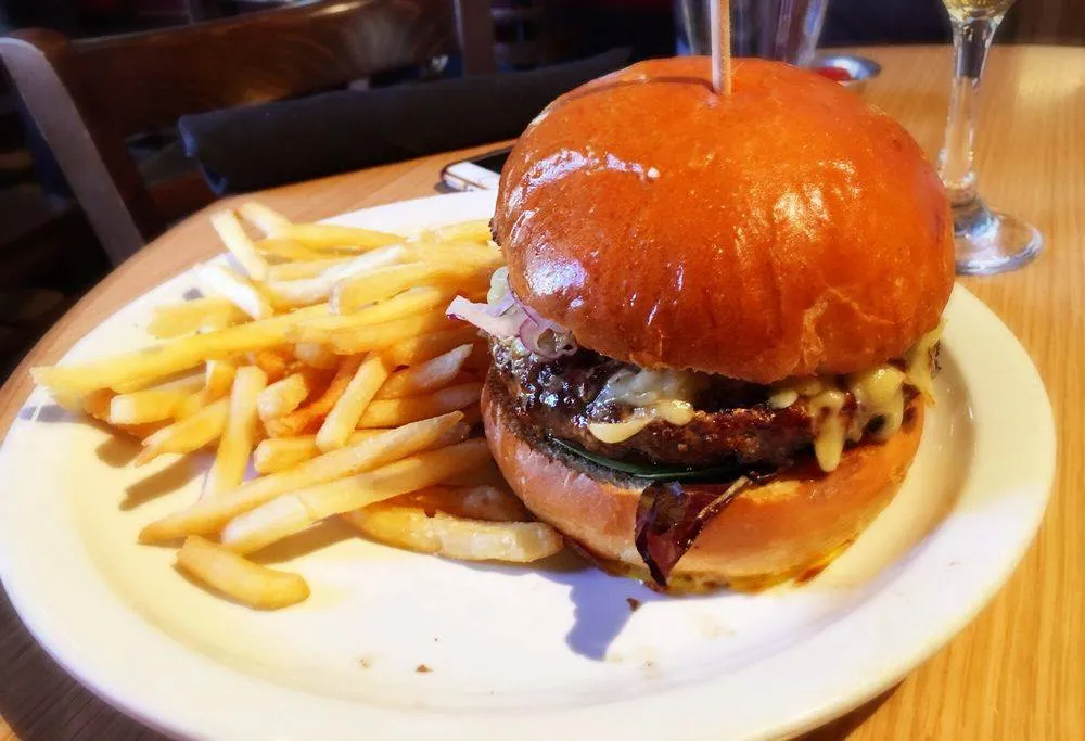 Classic Irish-pub cheeseburger with fries, like the burger at Oscar’s in Luxembourg’s Grund