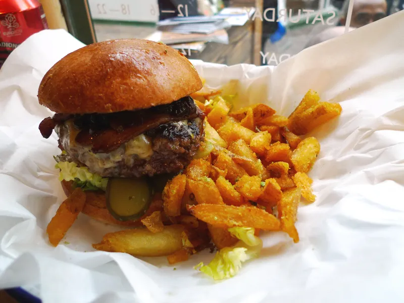 Bacon cheddar burger with fries, illustrating the best burger in Luxembourg City guide