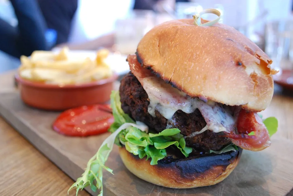 A5 wagyu burger patty in a sesame bun with melted cheese, New York wagyu burger
