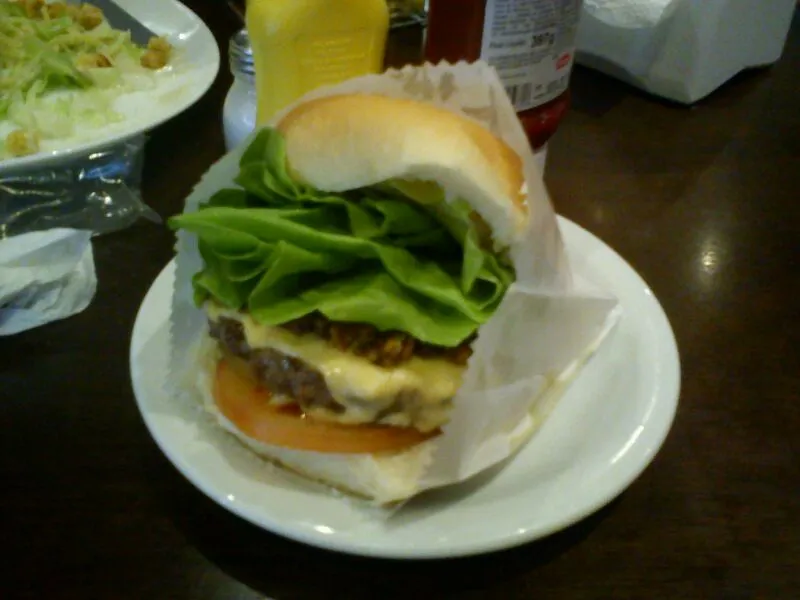 Classic São Paulo X-Salada cheeseburger with lettuce and tomato at Sujinho, an old-school lunch-counter burger