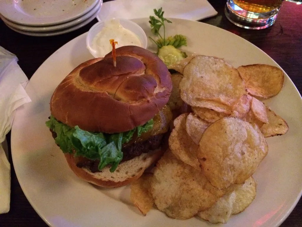 Pretzel bun burger with lettuce and melted cheese, the bun style of Burger King’s Game Day Pretzel Burger
