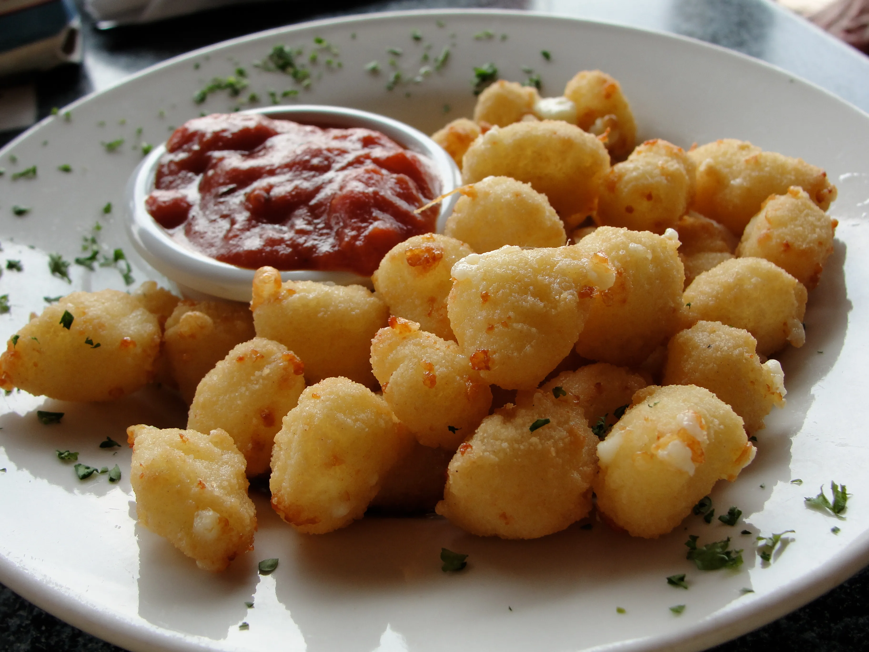 Fried cheese curds with marinara dip in Wisconsin, the topping idea behind Culver’s Smoked Cheddar CurderBurger