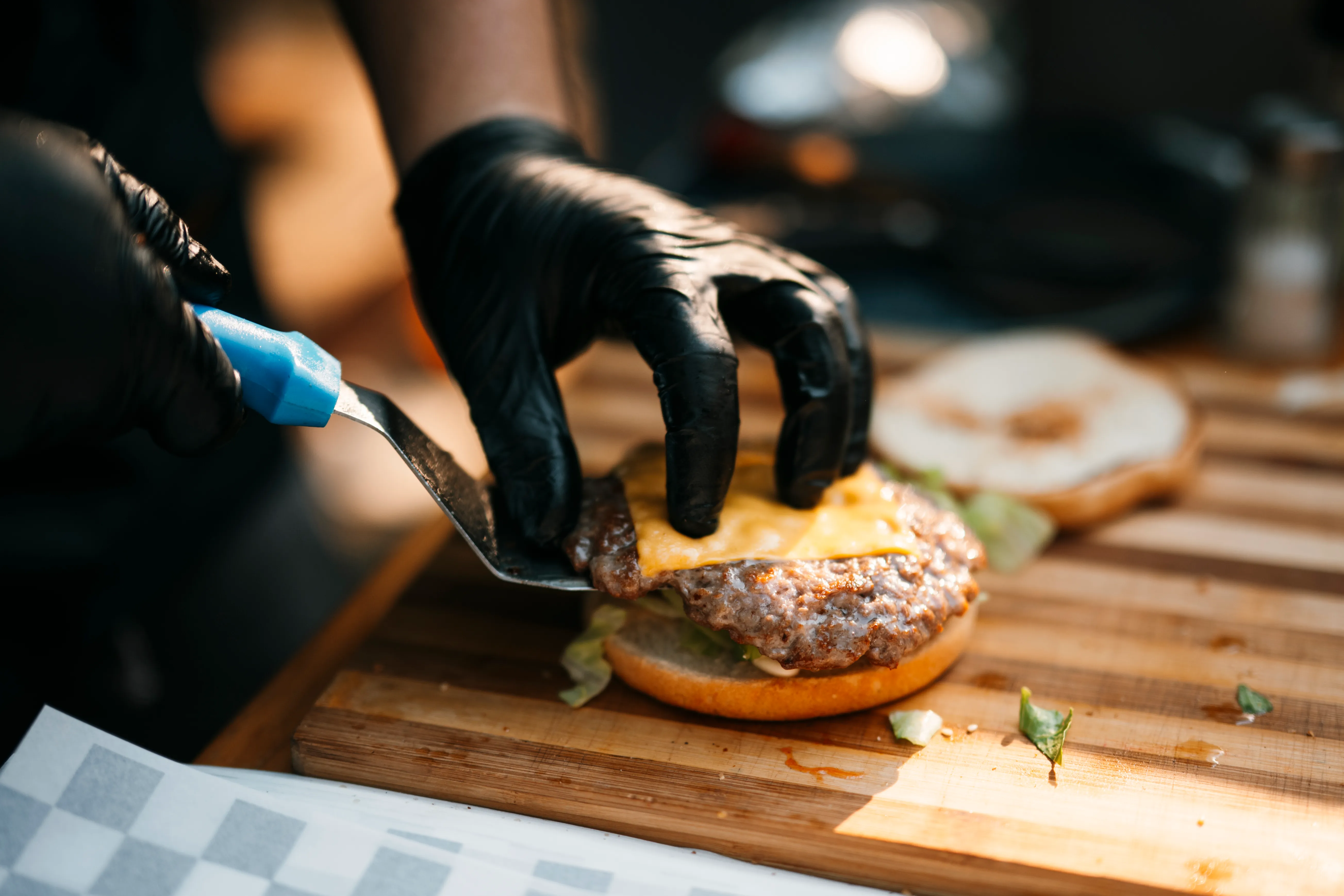 Laying a slice of cheese on a patty right after the flip so it melts over the last minute with the grill lid closed