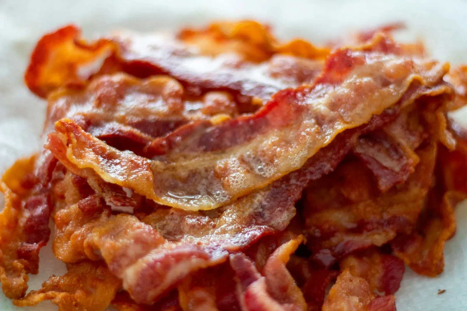 Crisp drained bacon strips ready to top a Five Guys copycat bacon cheeseburger