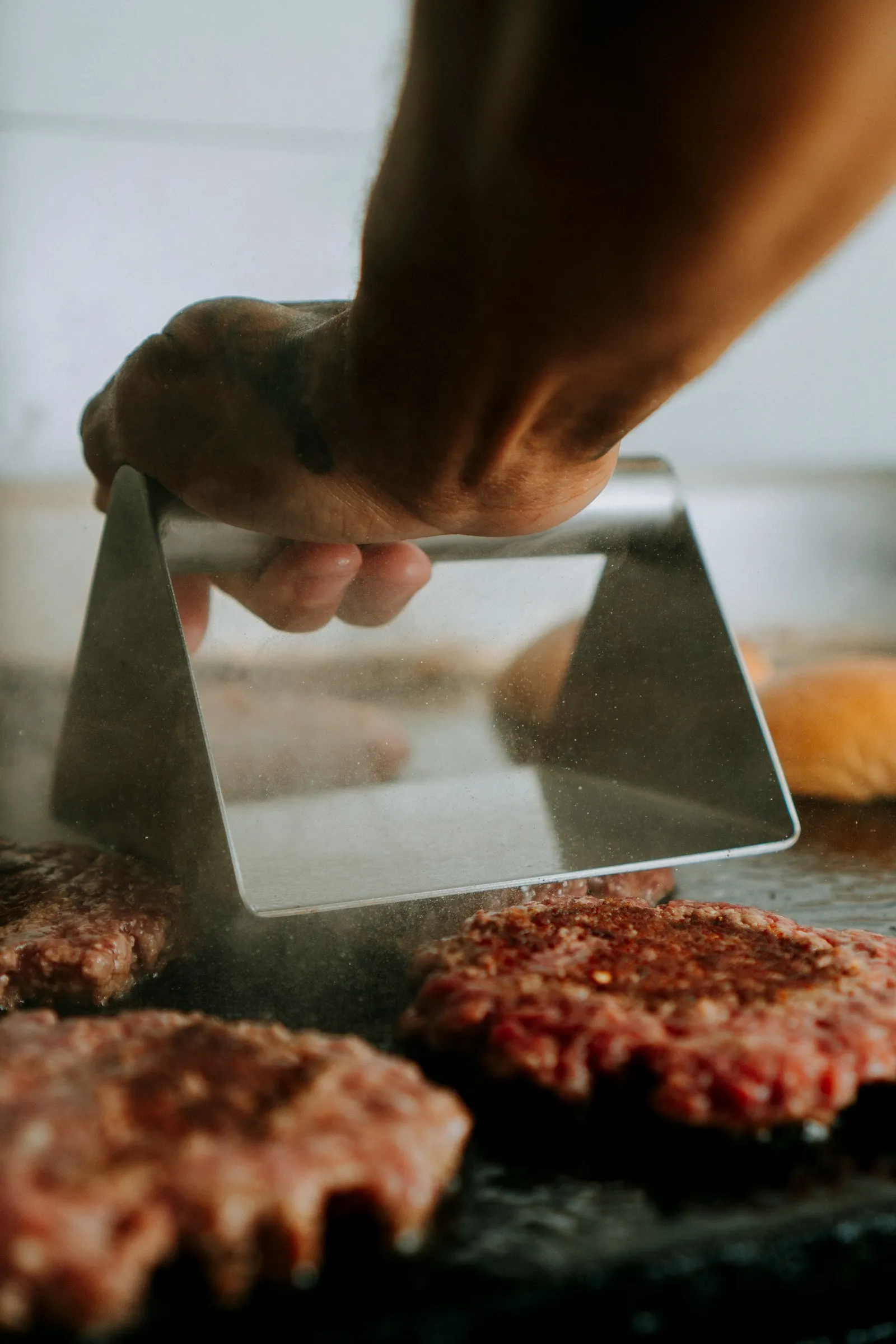 Hands shaping balls of ground beef into burger patties on a sheet, the first step of a Five Guys Little Cheeseburger copycat