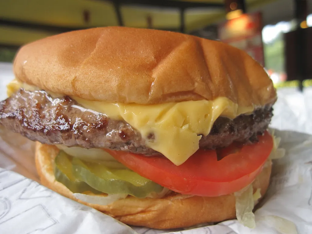 Assembled Little Hamburger with All The Way grilled onions, mushrooms, lettuce, pickles and tomato