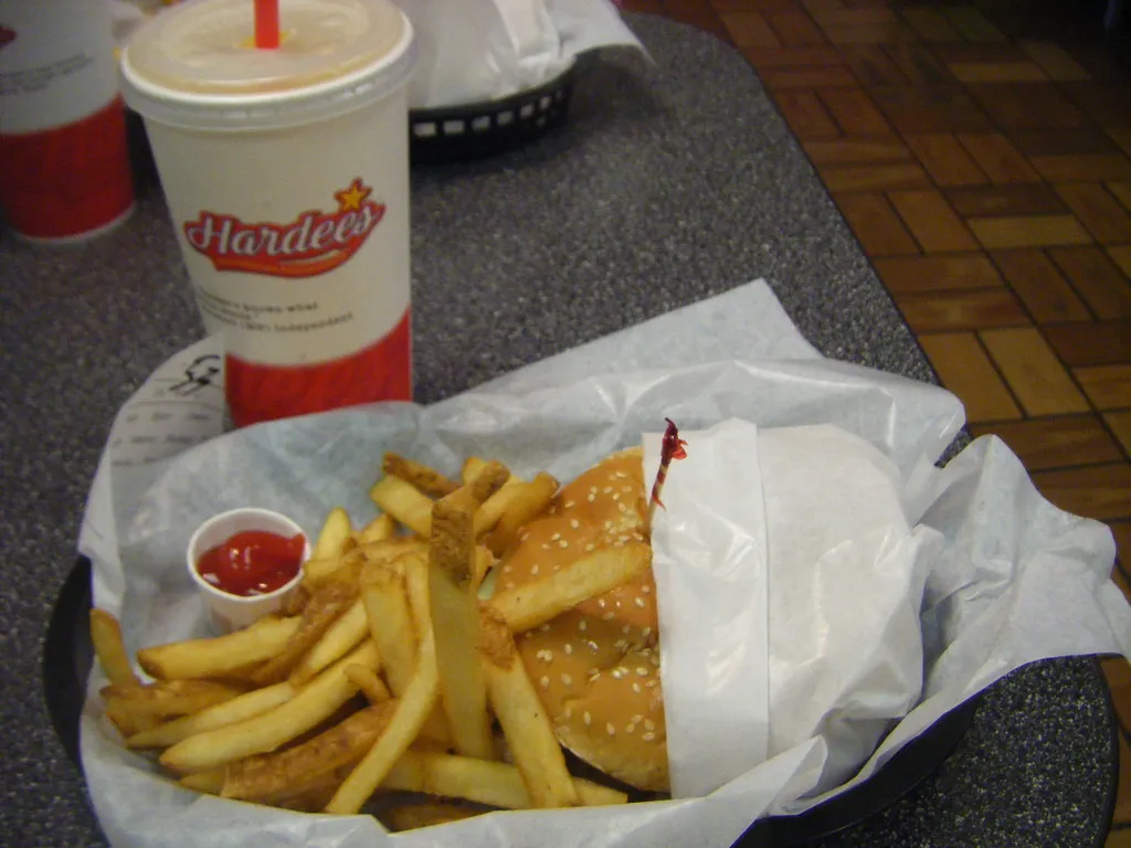 Hardee’s meal from 2008: a wrapped sesame-bun burger, fries and ketchup in a basket next to a Hardee’s cup