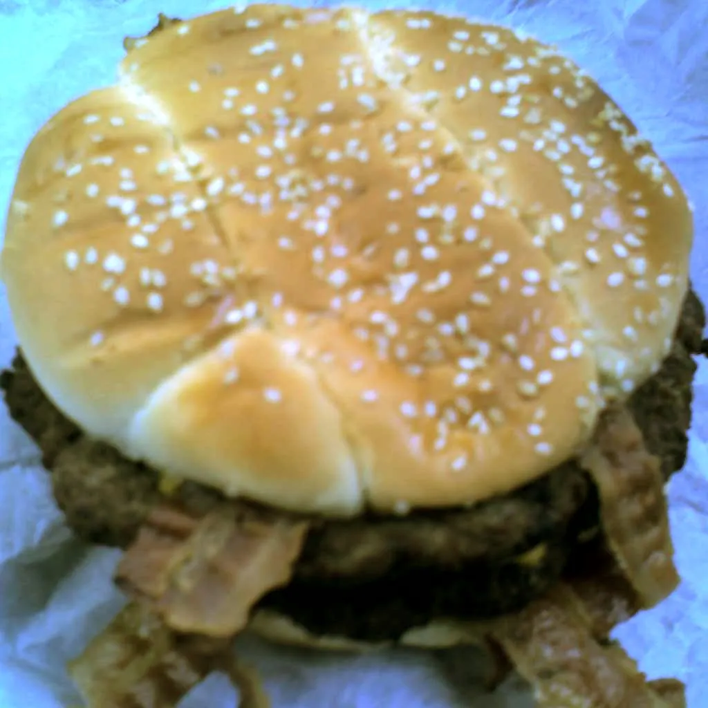 Hardee's Monster Thickburger with two charbroiled Angus patties, bacon and American cheese on a sesame bun, served in 2008