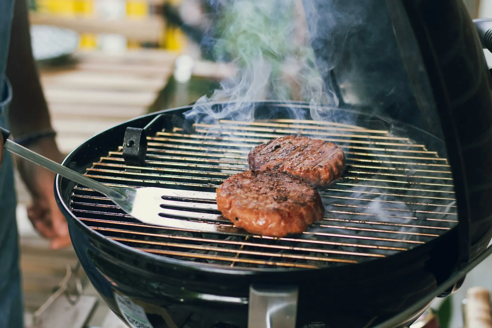 Thick burger patties with char marks on a hot grill, the grilling step of the Big Jack Angus recipe