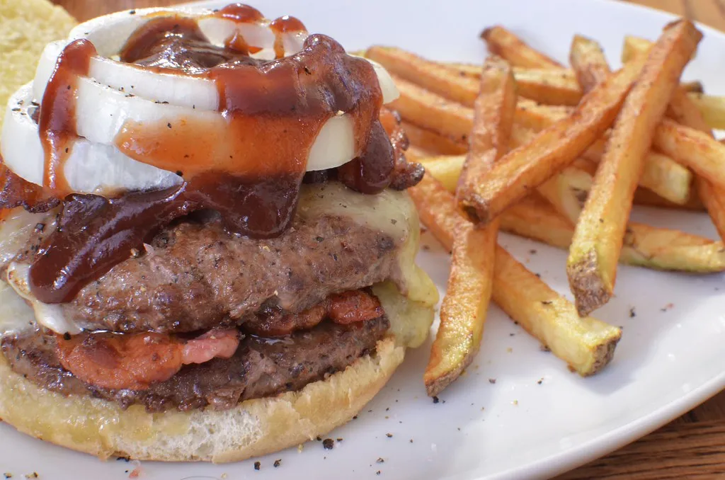 Ultimate Double Whopper copycat cut open showing double flame-grilled beef, melted cheese and bacon in toasted sesame bun