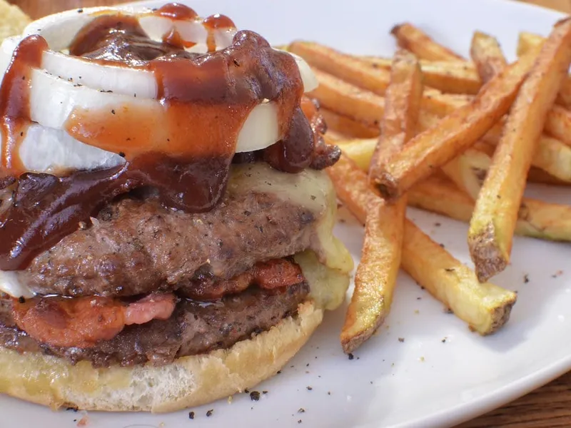 Ultimate Double Whopper copycat cut open showing double flame-grilled beef, melted cheese and bacon in toasted sesame bun
