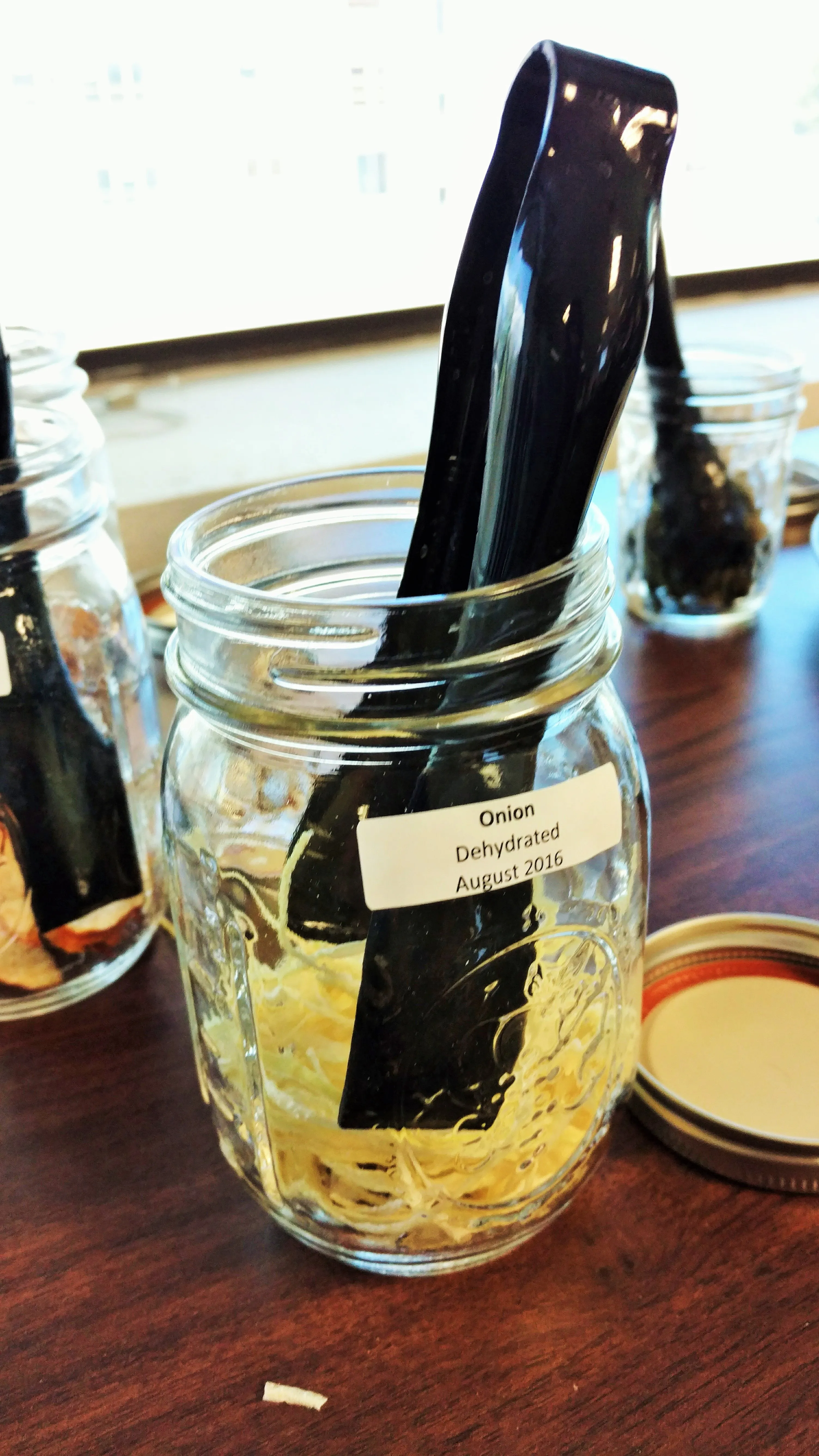 Glass jar of dehydrated onion, the dried minced onion to rehydrate for McDonald’s-style onions in a McDouble copycat