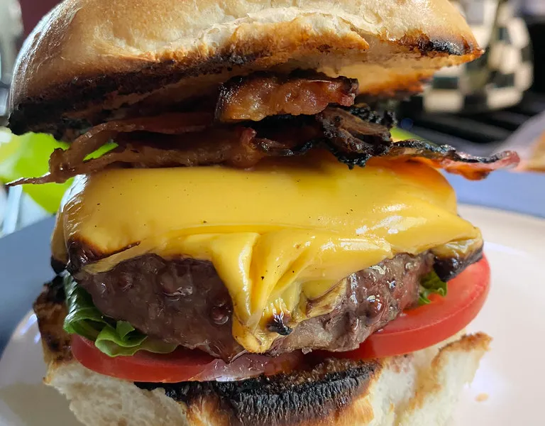 Sonic SuperSONIC Bacon Double Cheeseburger copycat base: homemade bacon cheeseburger with melted American cheese, crisp bacon, tomato and lettuce on a toasted white bun