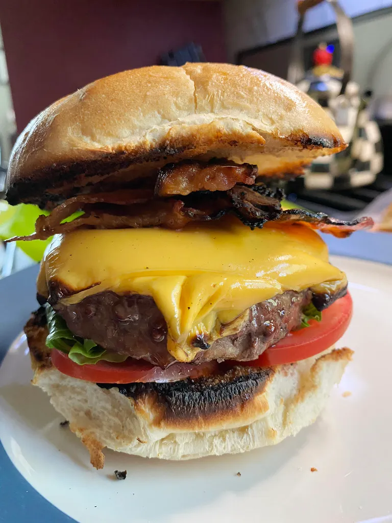 Sonic SuperSONIC Bacon Double Cheeseburger copycat base: homemade bacon cheeseburger with melted American cheese, crisp bacon, tomato and lettuce on a toasted white bun