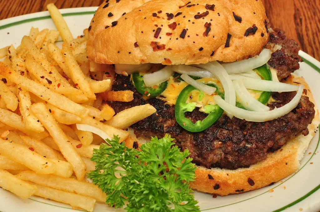 Two Sonic jalapeno double cheeseburger copycats with melted cheddar and jalapeno slices on a tray
