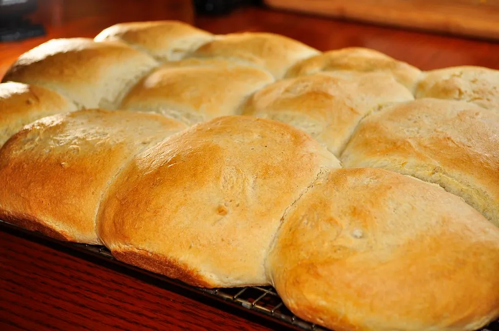 Butter-toasted burger buns browning cut-side down in a skillet