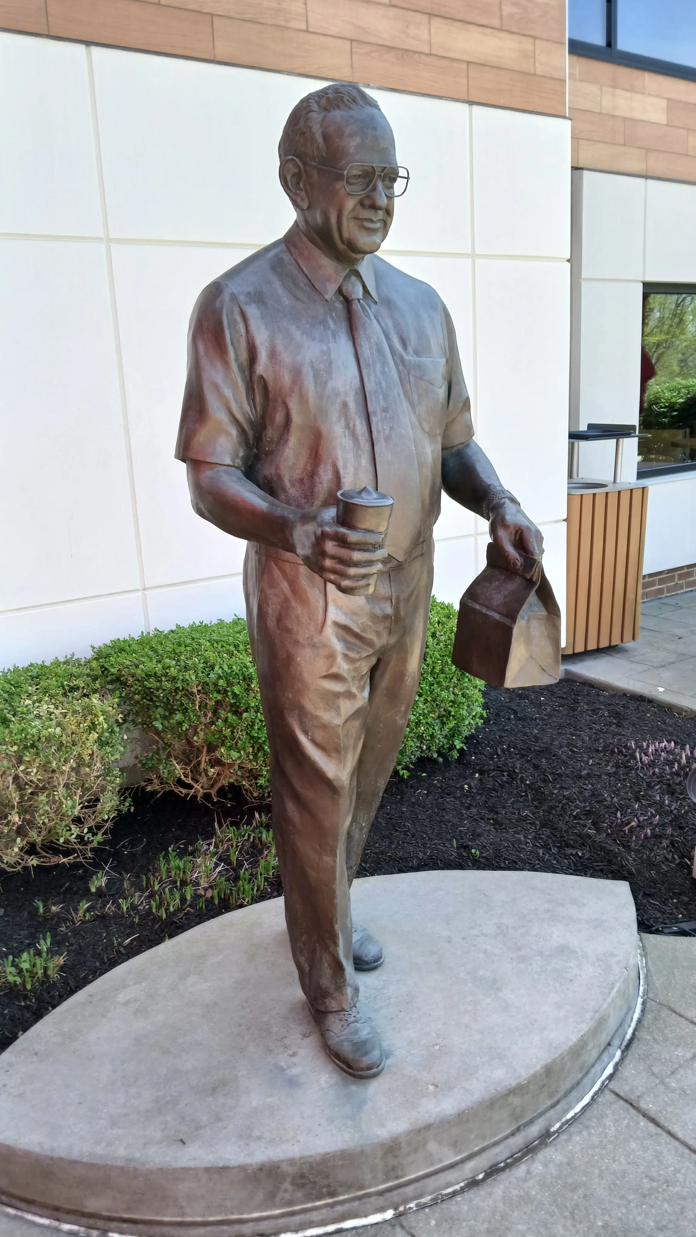 Bronze statue of Wendy’s founder Dave Thomas holding a cup and a takeout bag outside the Wendy’s flagship restaurant in Ohio