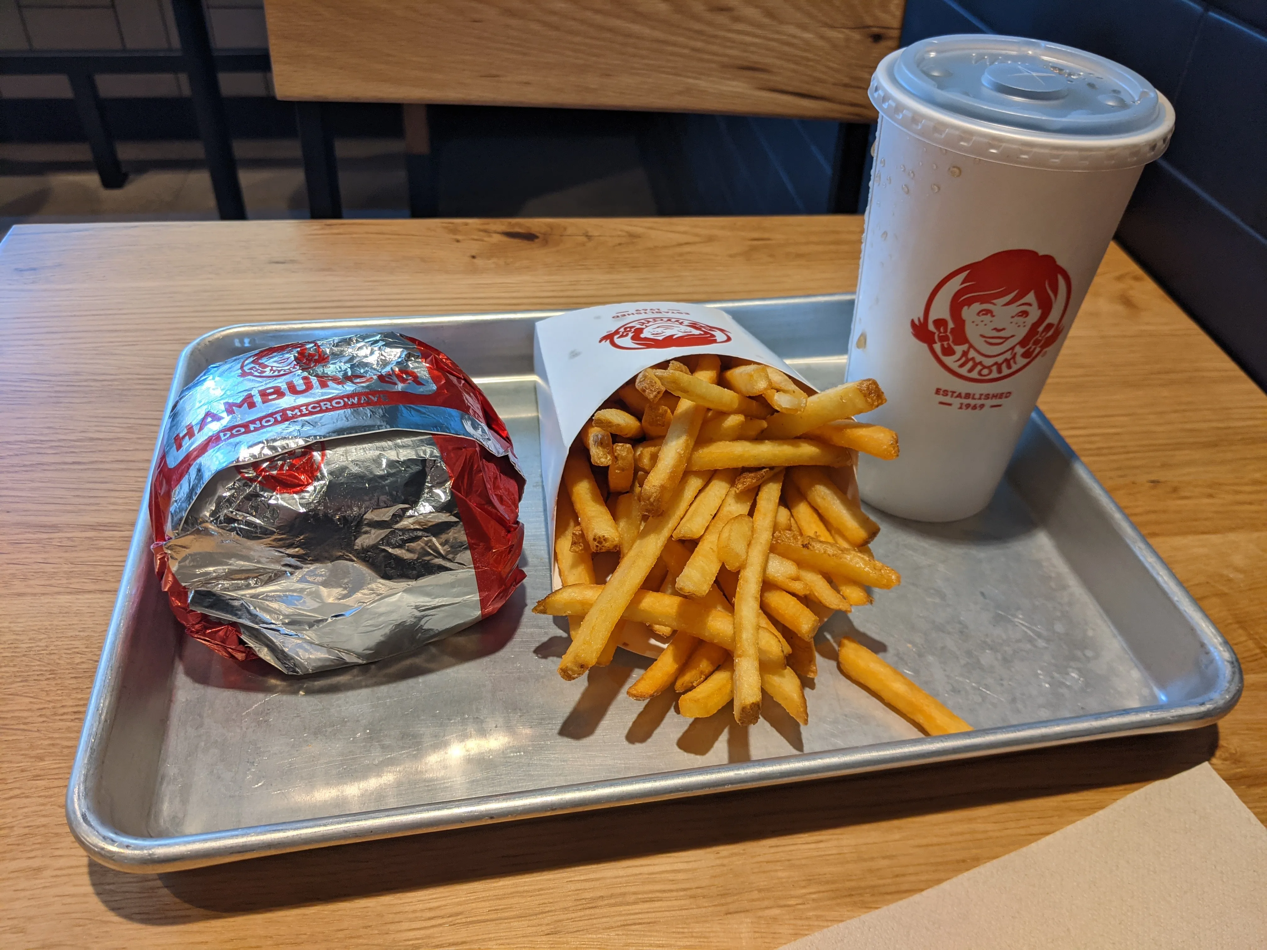 Wrapped Wendy’s Dave’s Double with fries and a soda on a tray in Stratford, London