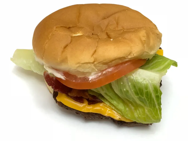 Wendy's Jr. Bacon Cheeseburger with a square beef patty, melted American cheese, bacon, lettuce, tomato and mayo on a plain bun