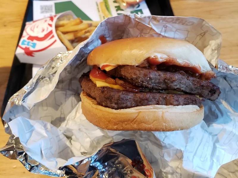 Baconator de Wendy's, hermano mayor del Son of Baconator, con dos filetes cuadrados que asoman del pan tostado y bacon crujiente