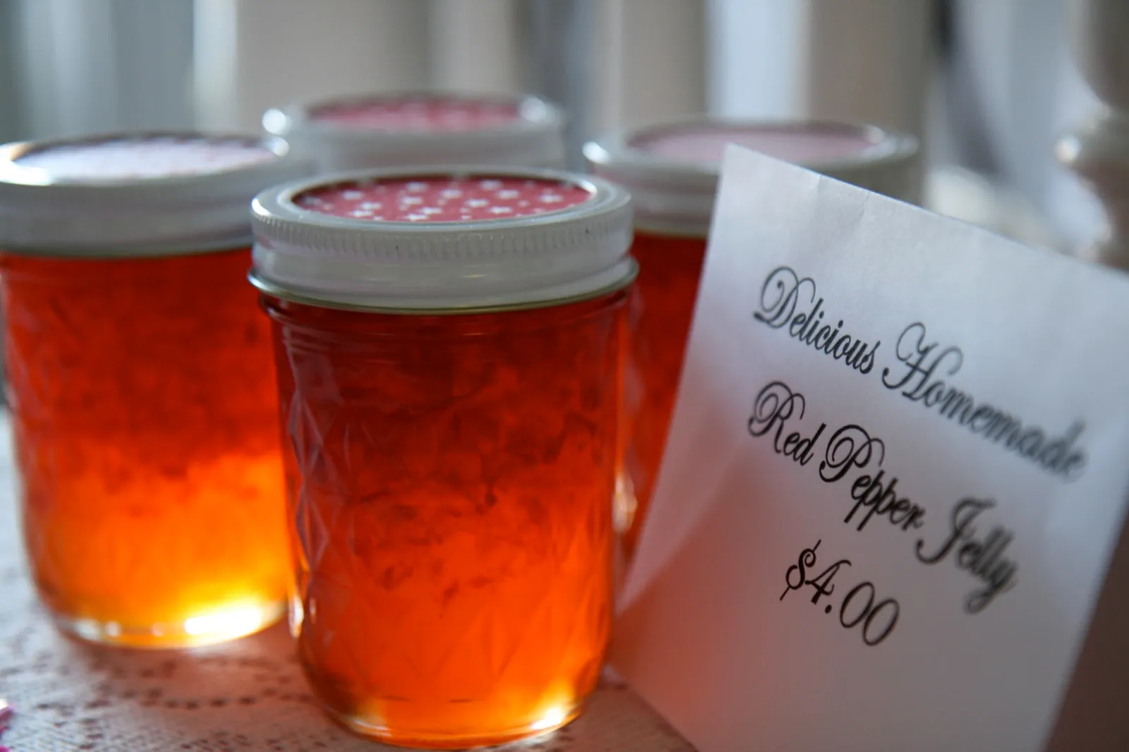 Jar of red pepper jelly, the sweet base of the homemade Whataburger sweet and spicy sauce