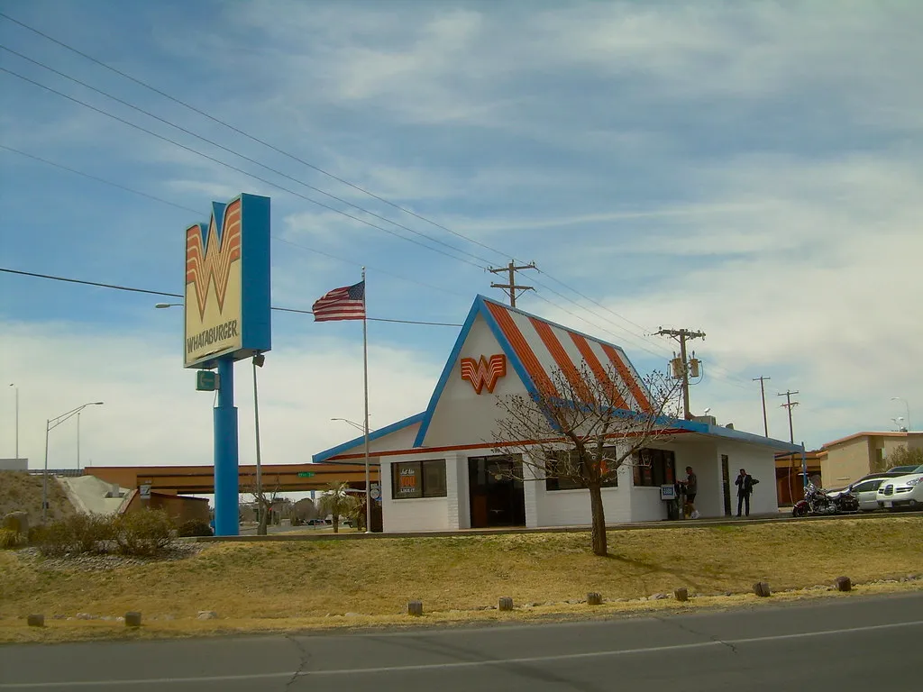 Whataburger restaurant with its orange-and-white A-frame roof and W pole sign in Las Cruces, New Mexico