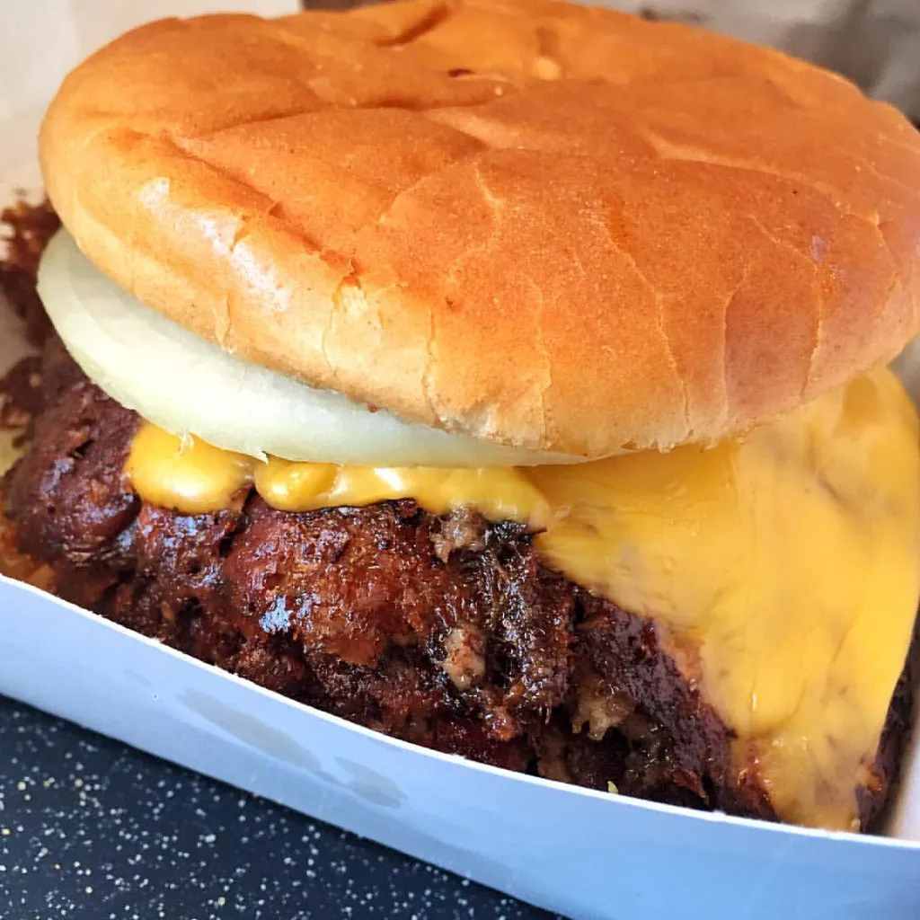 Triple meat Whataburger copycat triple-stack burger with mustard and pickles in a toasted 5-inch bun