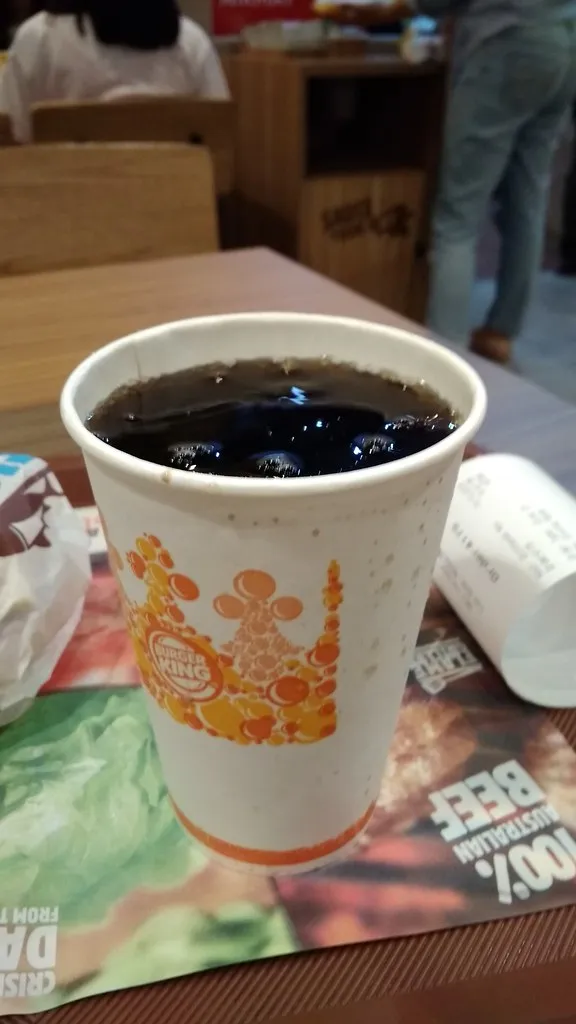 A Burger King meal with a burger, fries and a drink