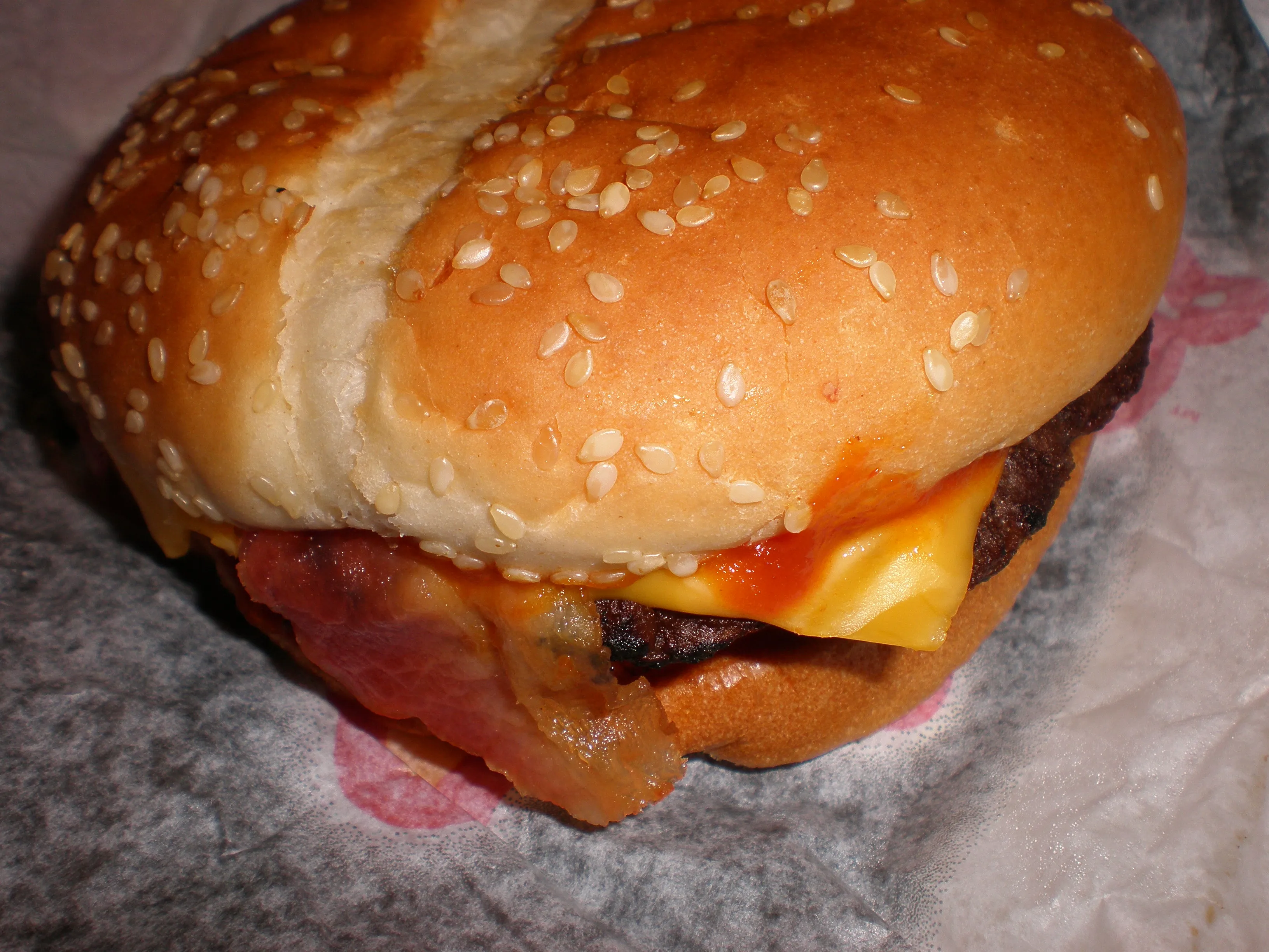 Carl’s Jr. Western Bacon Cheeseburger with onion rings and BBQ sauce