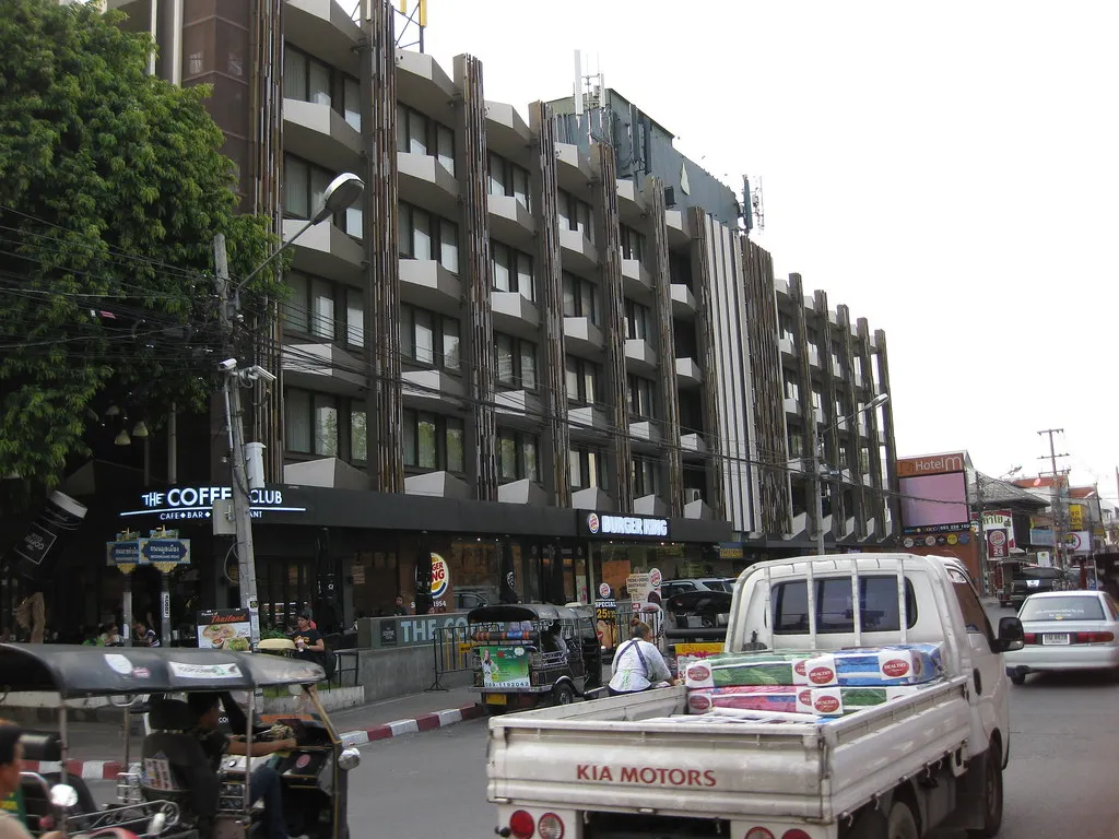 Burger King Chiang Mai storefront at Tha Phae Gate on Ratchadamnoen Road, next to The Coffee Club, with tuk-tuks in the street