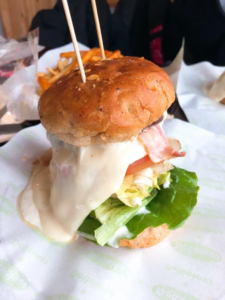 Korean handmade burger with bacon, melted cheese, tomato and lettuce, served with fries