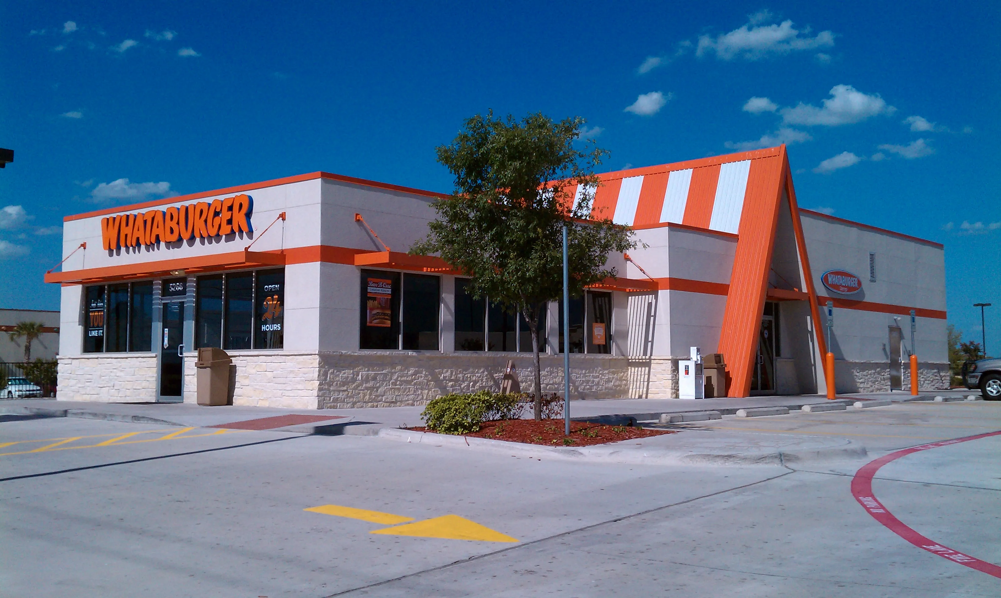 Orange-and-white Whataburger restaurant in Frisco, Dallas area, with an Open 24 Hours sign