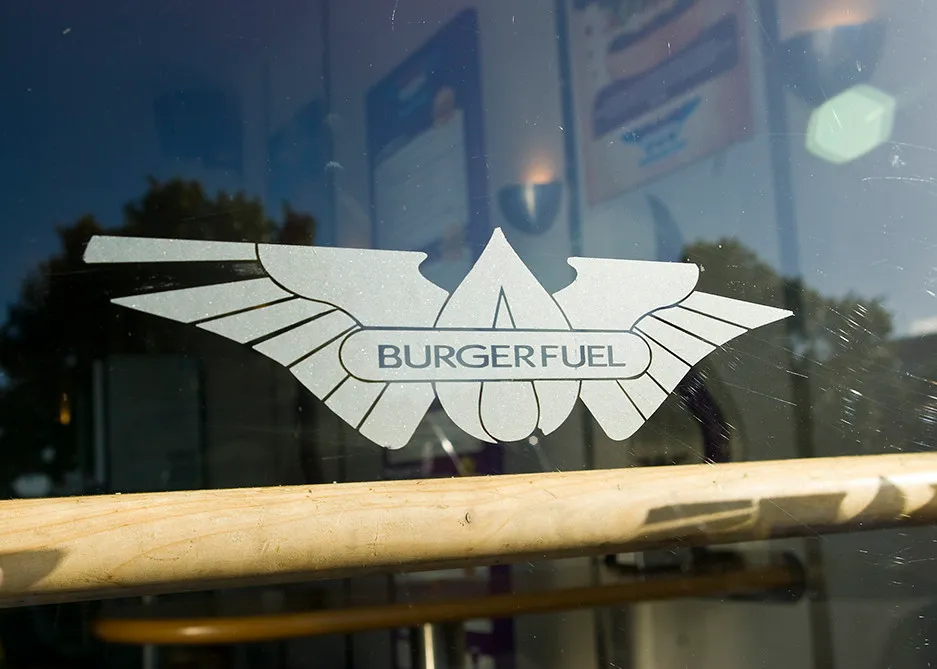Winged BurgerFuel logo on the window of a BurgerFuel restaurant in New Zealand
