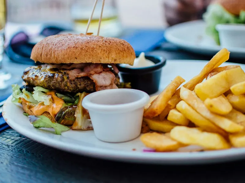 Hamburguesa gourmet con patatas fritas, del estilo de las que sirve Burger Boutique Yeda en City Yard, Ar Rawdah (foto ilustrativa, no tomada en el local)