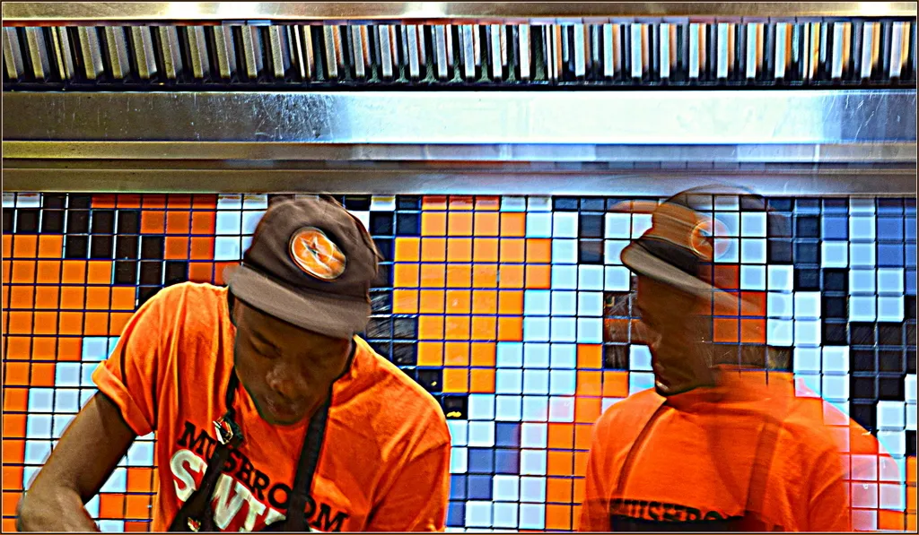 Chefs in the open kitchen of a RocoMamas smash burger restaurant in South Africa, illustrating the RocoMamas Johannesburg chain