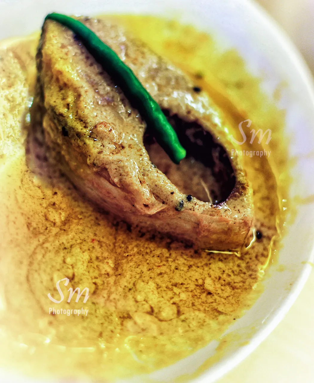 Shorshe ilish, hilsa fish in mustard gravy, a signature Bengali dish to order at 6 Ballygunge Place Kolkata