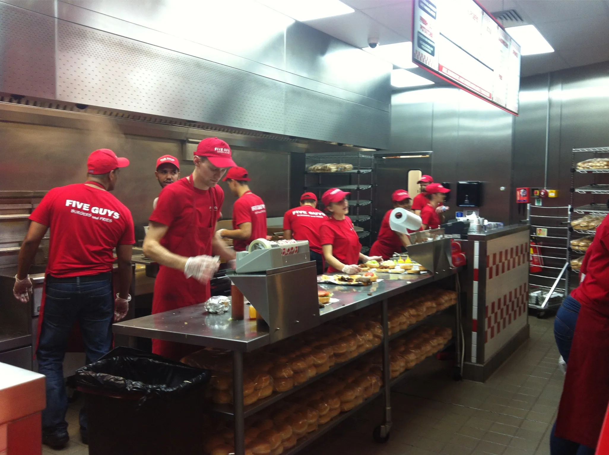 Staff preparing burgers at Five Guys Covent Garden, the chain’s first UK restaurant in London