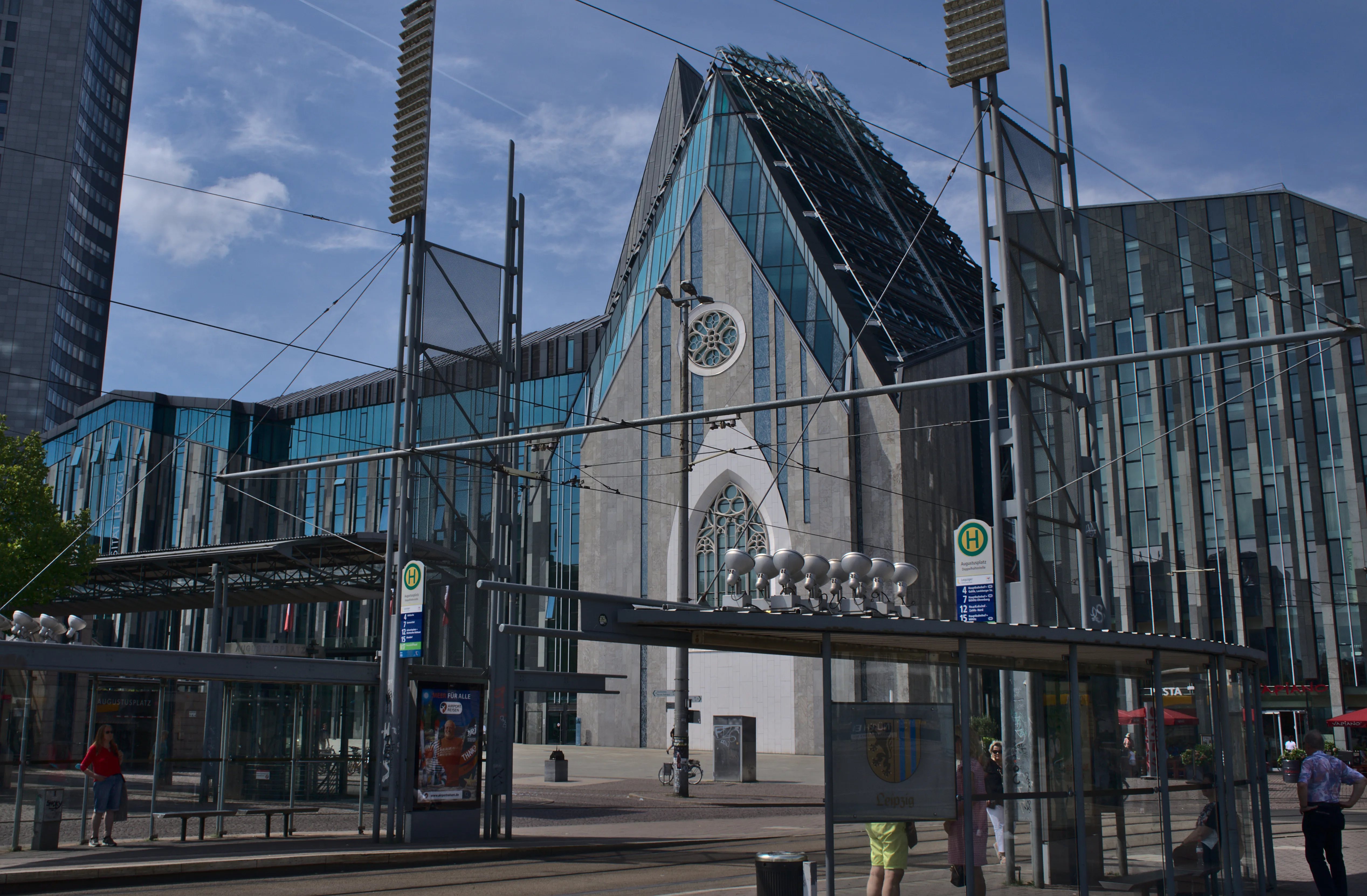 Augustusplatz tram stop in Leipzig, the closest stop to Hans im Glück Leipzig, with the Paulinum university church behind it