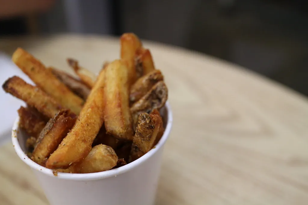 Cup of Five Guys Cajun fries, hand-cut and cooked in peanut oil