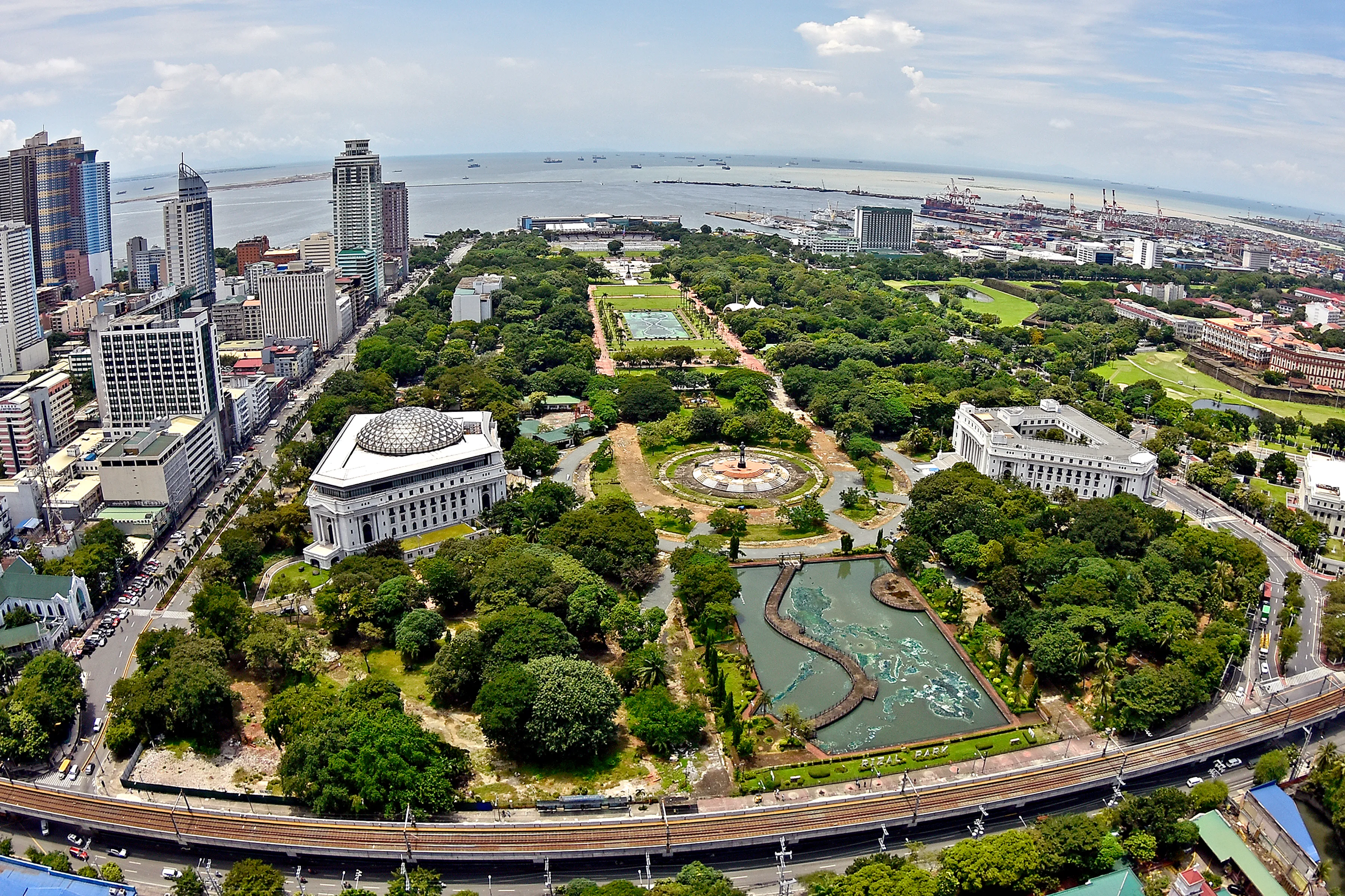 Rizal Park (Luneta) in Manila seen from above, with the National Museum buildings and Manila Bay, near Jollibee Rizal Park on Kalaw Avenue