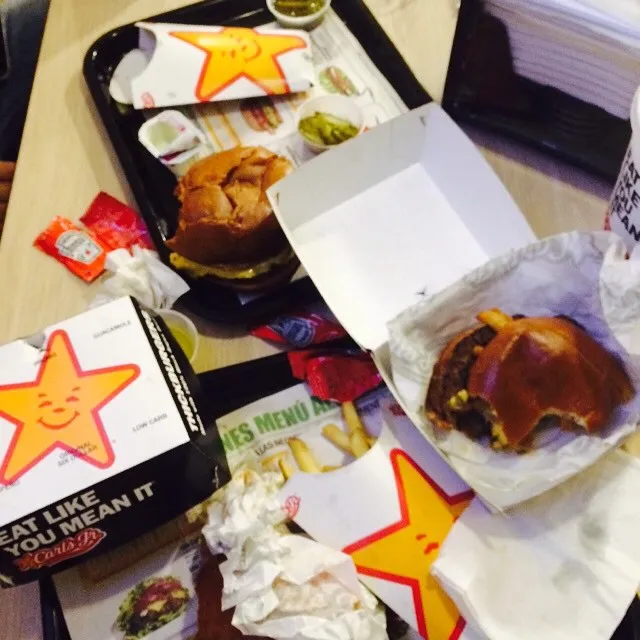 Carl’s Jr. burgers, fries and pickles on a tray with star packaging at a Carl’s Jr. in Mexico