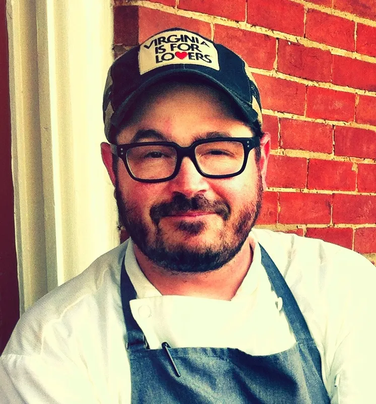Chef Sean Brock, founder of the Joyland Nashville burger counter, in a chef's jacket and apron in 2013