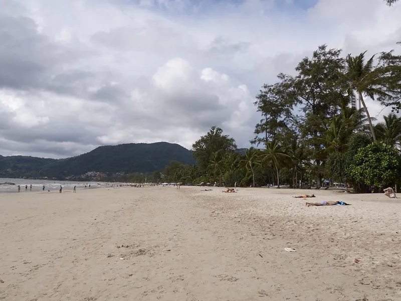 Patong Beach in Phuket lined with palm trees, near the Prime Burger Phuket smash burger branch at Central Patong