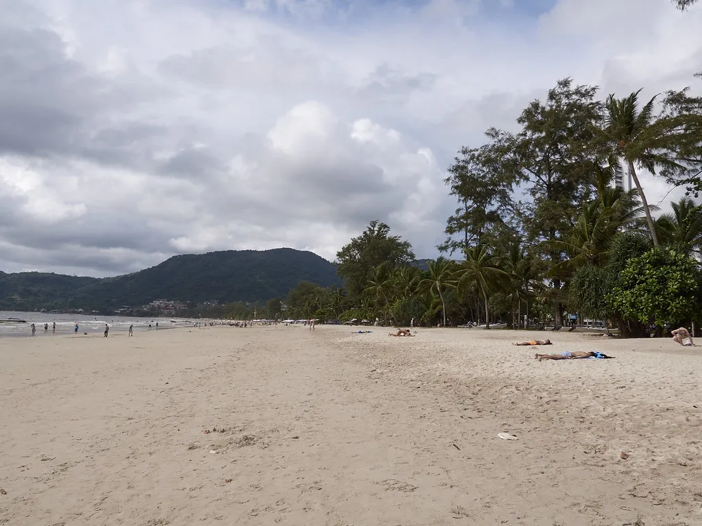 Patong Beach in Phuket lined with palm trees, near the Prime Burger Phuket smash burger branch at Central Patong