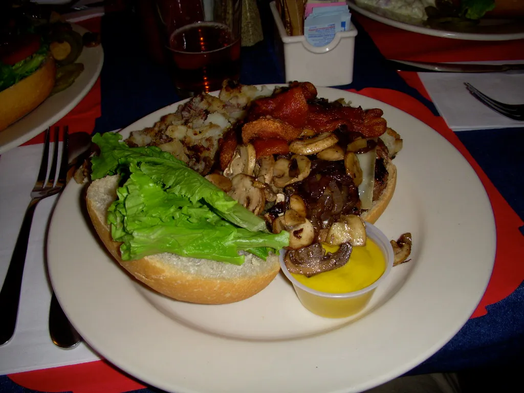 Tessaro’s burger with bacon, grilled mushrooms and onions, the Gourmet Kelly Burger toppings, served with home fries