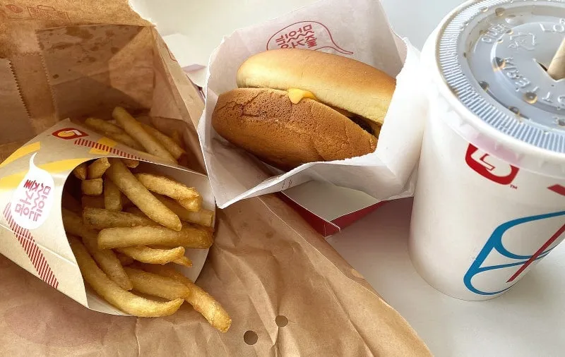 Lotteria cheeseburger set in Korea with fries and a cola