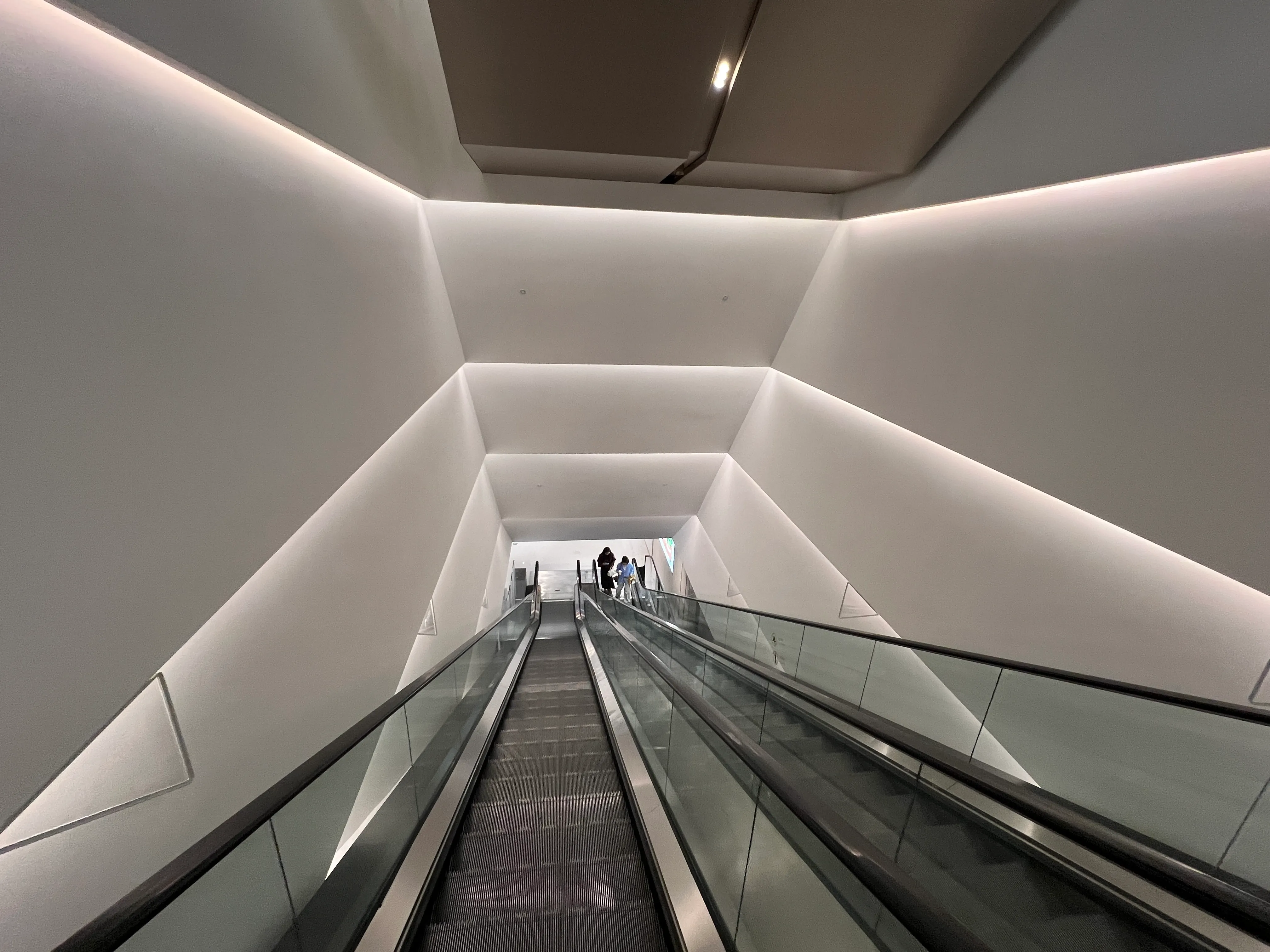 Escalator inside MixC Shenzhen Bay mall, where Honbo Shenzhen sits on basement level B1 of Block B
